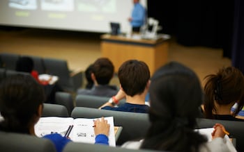 Students reading book in class