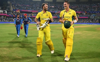 Glenn Maxwell of Australia celebrates with team-mate Pat Cummins after hitting a six for the winning runs, finishing unbeaten on 201 not out during the ICC Men's Cricket World Cup India 2023 between Australia and Afghanistan at Wankhede Stadium on November 07, 2023 in Mumbai, India