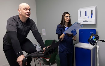 Sam Delaney having his cardiovascular details checked while exercising on a watt bike