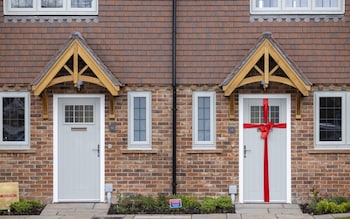 A door wrapped in ribbon at a residential construction site in Cranleigh