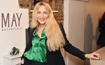 Supermodel Jerry Hall in a striking emerald green satin shirt