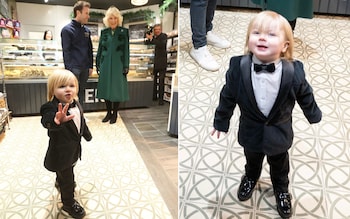 Fitzwilliam Corrie-Salmon photobombs the Queen as she visits Knotts Bakery in Belfast