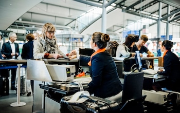 Travellers at an airport check-in counter 